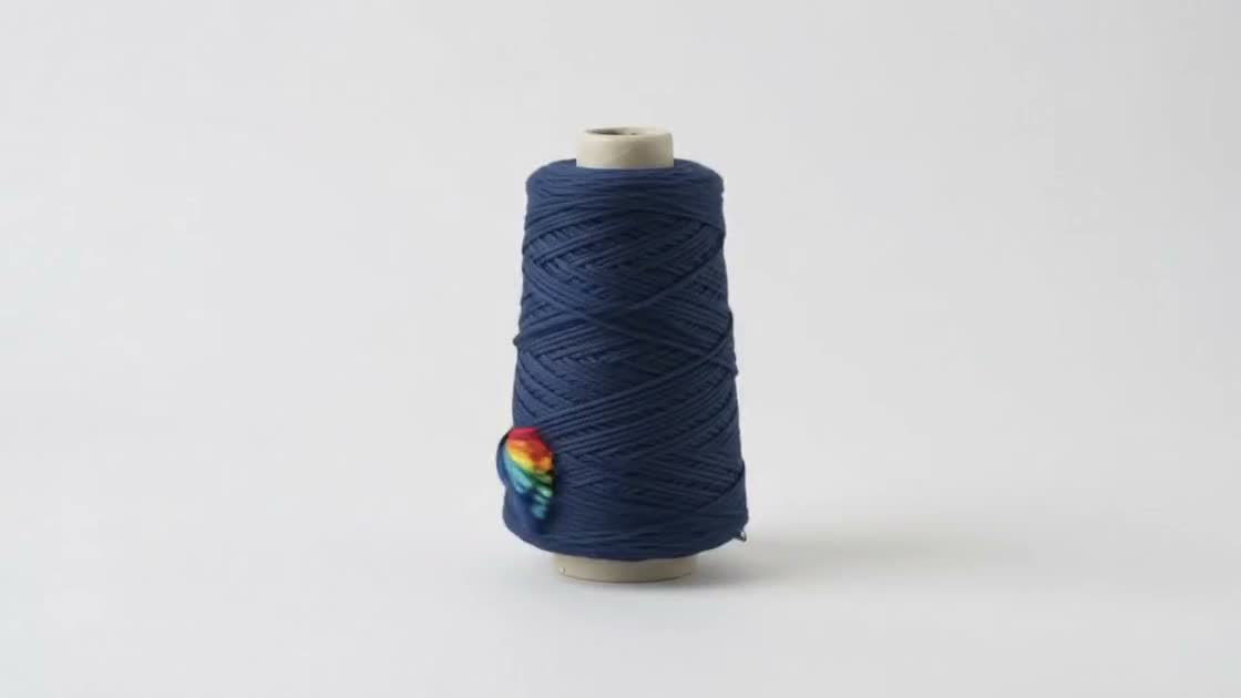 A cone of yarn taking colour